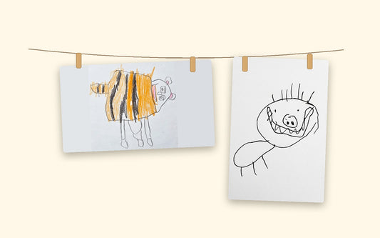 Two children's drawings, a striped creature and a grinning pig-faced creature, pegged on a string like a home gallery