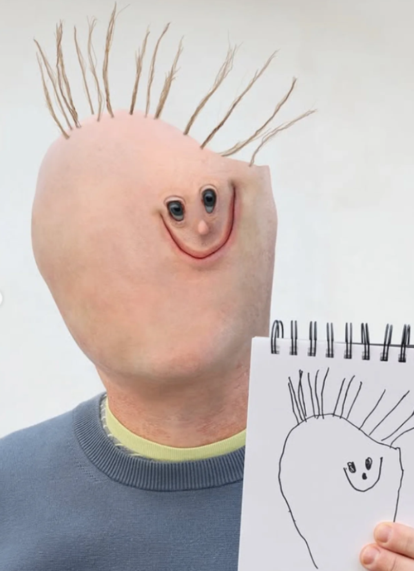 A child's drawing of a creature whose head fills half the page, beside the photographed version.